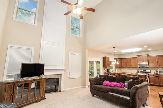 4889 Arbor View Pkwy NW, Acworth, GA 30101 - living room featuring a towering ceiling, ceiling fan, plenty of natural light, a fireplace with flush hearth, and a chandelier
