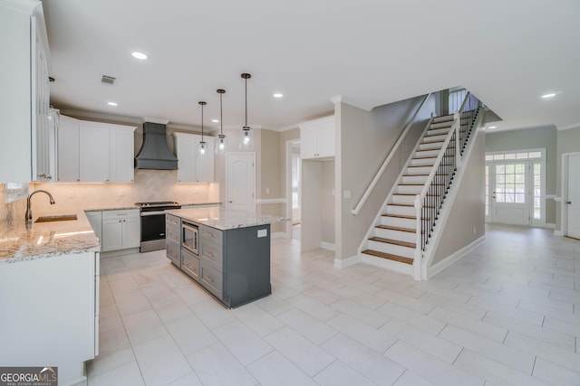 351 Chandler Bluff Ct, Grayson, GA 30017 - kitchen with custom range hood, appliances with stainless steel finishes, a sink, backsplash, and light stone counters