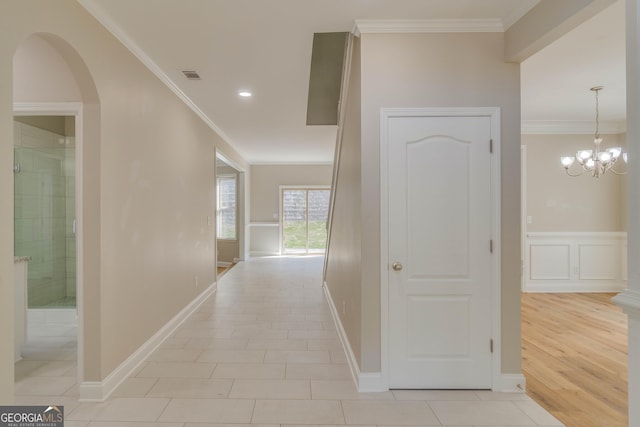 351 Chandler Bluff Ct, Grayson, GA 30017 - hallway featuring crown molding, arched walkways, a chandelier, light tile patterned floors, and recessed lighting