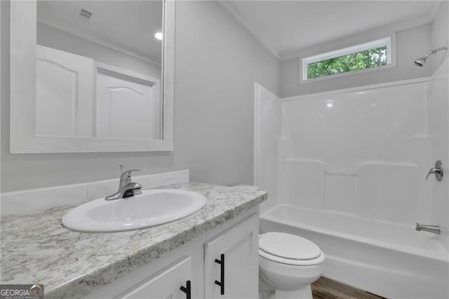 bathroom with toilet, vanity, bathing tub / shower combination, and wood finished floors