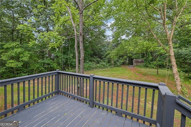wooden deck featuring a lawn