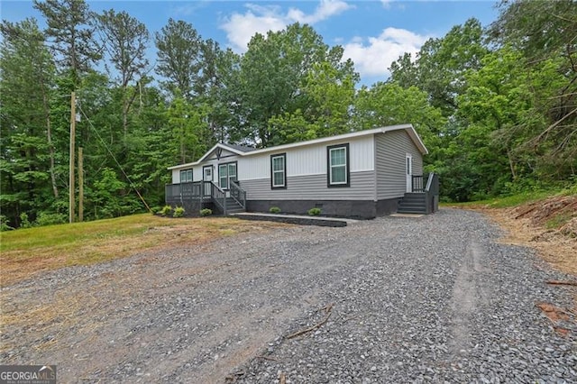 manufactured / mobile home with gravel driveway and crawl space