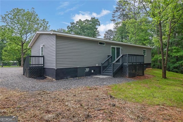 rear view of house featuring a wooden deck and crawl space