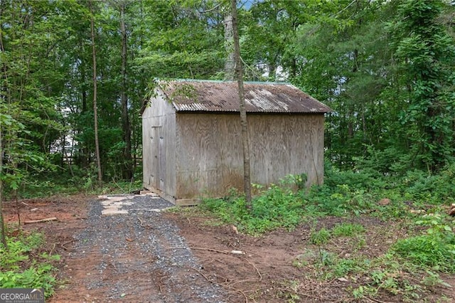 view of shed with a forest view