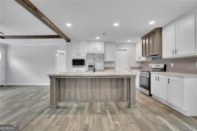 kitchen featuring stainless steel appliances, light wood-type flooring, backsplash, white cabinets, and recessed lighting