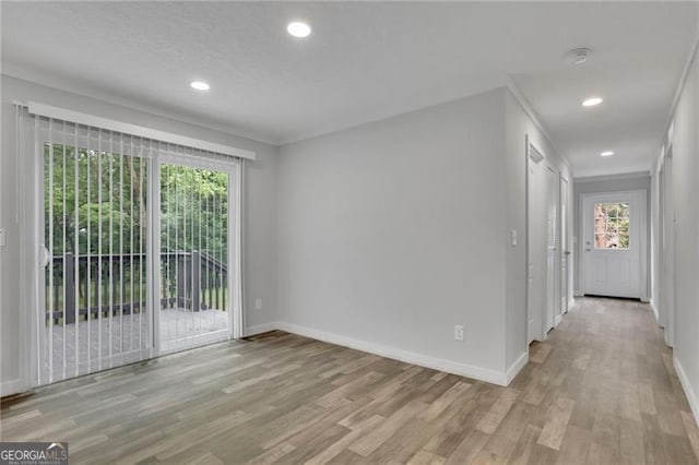 spare room featuring light wood-type flooring, baseboards, recessed lighting, and a smoke detector