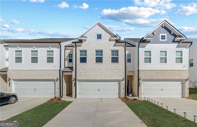 townhome / multi-family property featuring an attached garage and concrete driveway
