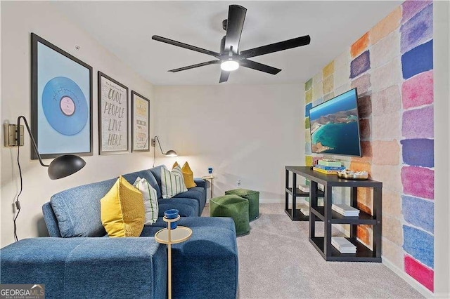 carpeted living room featuring a ceiling fan and baseboards