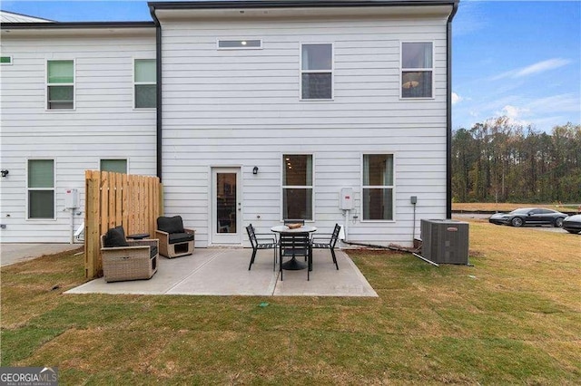 rear view of property featuring central AC, a patio area, and a yard