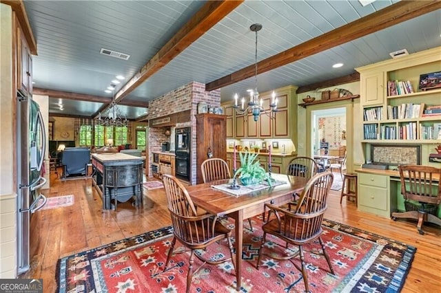5945 W Andechs Smt, Johns Creek, GA 30097 - dining area featuring a chandelier, light wood-style flooring, beamed ceiling, and a desk