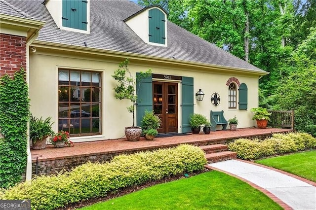 5945 W Andechs Smt, Johns Creek, GA 30097 - property entrance with stucco siding, a shingled roof, and a yard