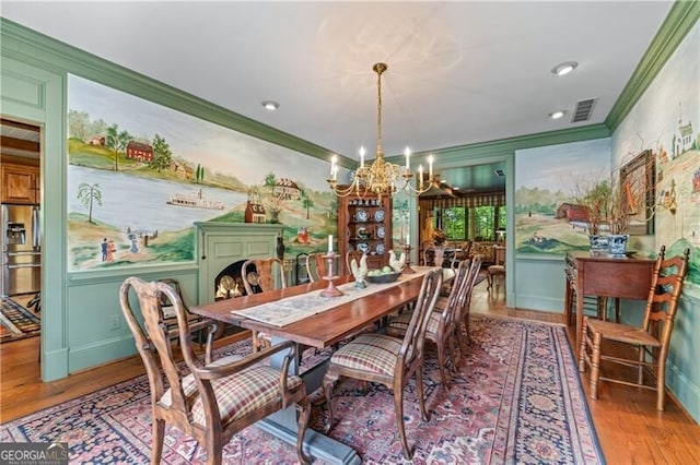 5945 W Andechs Smt, Johns Creek, GA 30097 - dining space with crown molding, a chandelier, wood finished floors, and baseboards