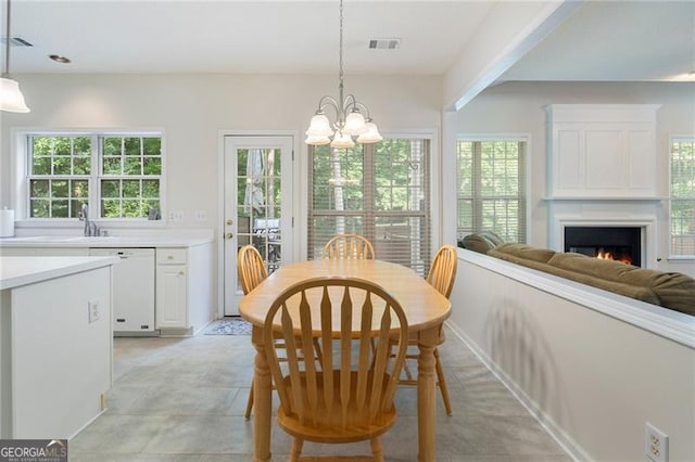 4321 Sugar Maple Chase NW, Acworth, GA 30101 - dining area featuring a chandelier and a lit fireplace