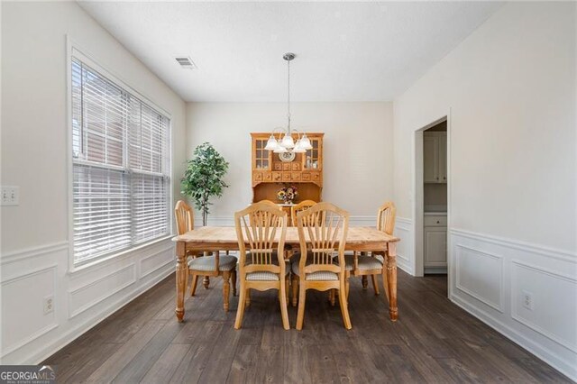 4321 Sugar Maple Chase NW, Acworth, GA 30101 - dining area with a chandelier, dark wood-type flooring, a wainscoted wall, and a decorative wall