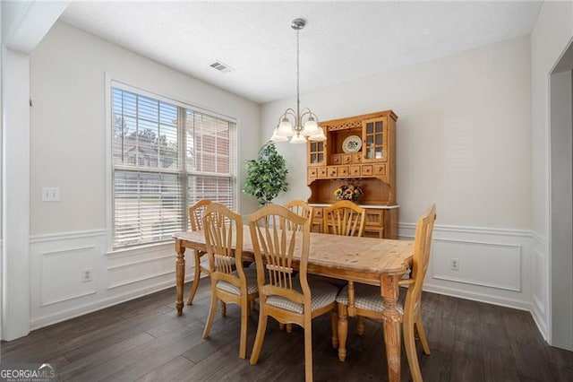 4321 Sugar Maple Chase NW, Acworth, GA 30101 - dining room featuring a chandelier, dark wood-type flooring, a wainscoted wall, and a decorative wall