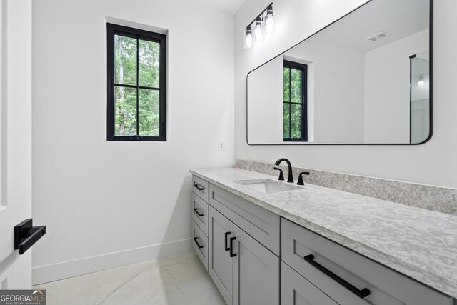 2595 Grassview Dr, Milton, GA 30004 - bathroom featuring marble finish flooring, baseboards, plenty of natural light, and vanity