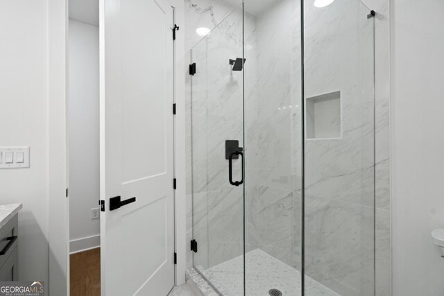 2595 Grassview Dr, Milton, GA 30004 - bathroom featuring a marble finish shower, vanity, toilet, and wood finished floors