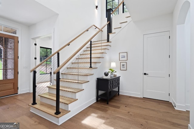 2595 Grassview Dr, Milton, GA 30004 - entrance foyer featuring stairs, wood finished floors, arched walkways, and baseboards