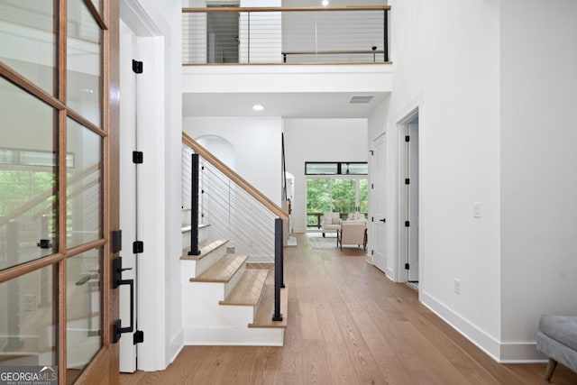 2595 Grassview Dr, Milton, GA 30004 - foyer entrance featuring baseboards, wood finished floors, stairs, and a high ceiling