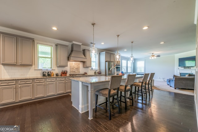 4752 Albany Way S, Fulton, GA 30331 - kitchen with custom range hood, gray cabinets, a breakfast bar area, appliances with stainless steel finishes, and dark wood-style floors