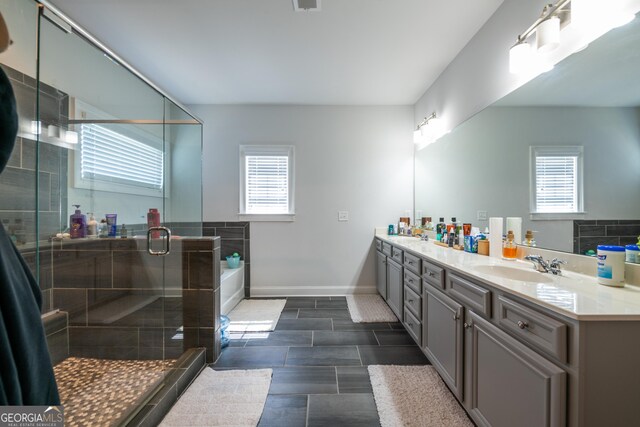 4752 Albany Way S, Fulton, GA 30331 - full bathroom featuring healthy amount of natural light, double vanity, a garden tub, and a stall shower