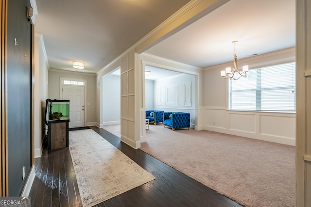 4752 Albany Way S, Fulton, GA 30331 - entryway featuring crown molding, a chandelier, dark wood finished floors, and a decorative wall