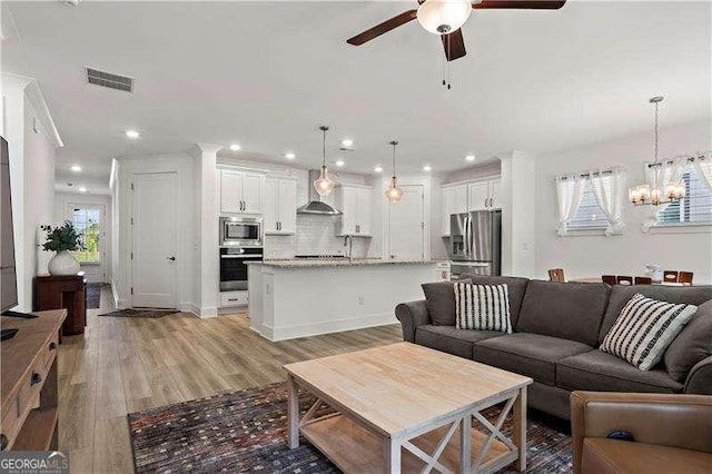 5121 Aster Bnd, Canton, GA 30114 - living area featuring a ceiling fan, a chandelier, light wood-style flooring, and recessed lighting