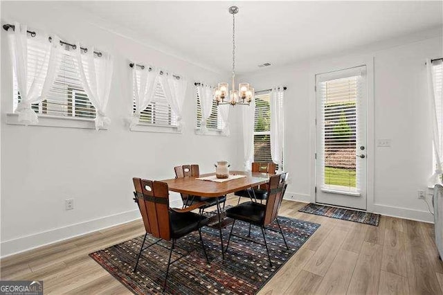 5121 Aster Bnd, Canton, GA 30114 - dining area with a chandelier, light wood-style floors, and baseboards