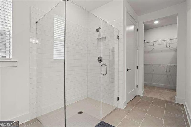 5121 Aster Bnd, Canton, GA 30114 - bathroom featuring a shower stall, a spacious closet, and plenty of natural light