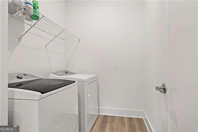 5121 Aster Bnd, Canton, GA 30114 - laundry room with washer and dryer, light wood-type flooring, and baseboards