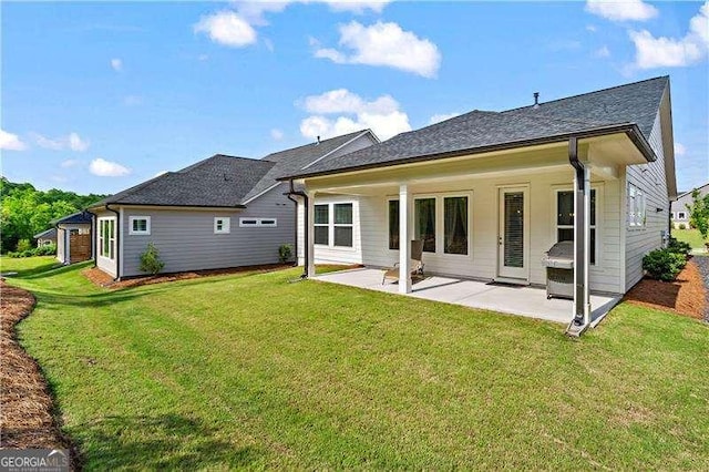 5121 Aster Bnd, Canton, GA 30114 - back of property featuring a patio area, a lawn, and a shingled roof