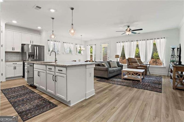 5121 Aster Bnd, Canton, GA 30114 - kitchen with a sink, stainless steel appliances, a ceiling fan, light wood finished floors, and recessed lighting