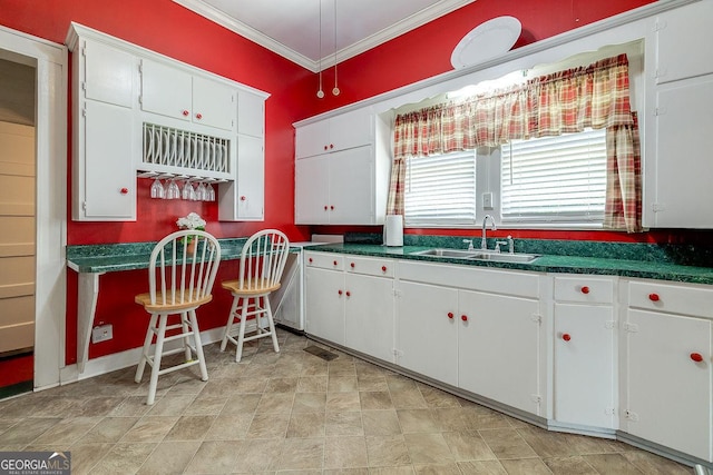 120 Newton St, Pooler, GA 31322 - kitchen featuring a sink, ornamental molding, white cabinets, and dark countertops