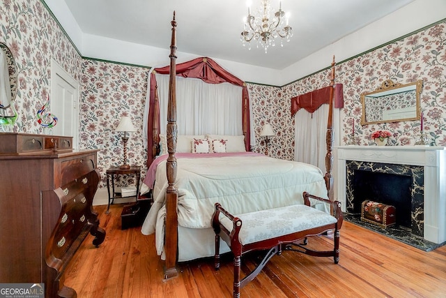 120 Newton St, Pooler, GA 31322 - bedroom with wallpapered walls, wood finished floors, a chandelier, and a premium fireplace