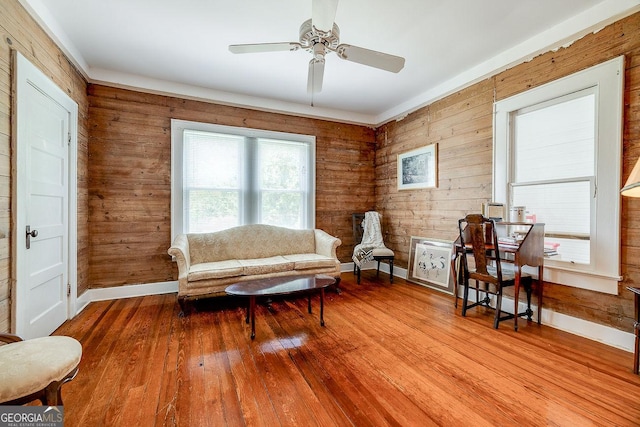 120 Newton St, Pooler, GA 31322 - living area featuring baseboards, wood walls, ceiling fan, and hardwood / wood-style flooring