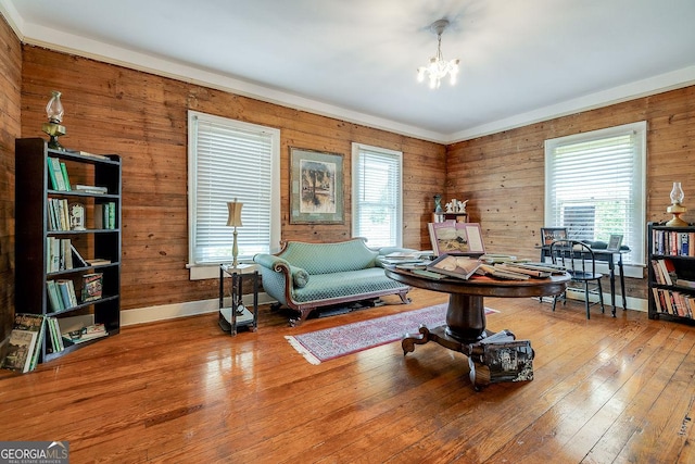 120 Newton St, Pooler, GA 31322 - sitting room featuring a chandelier, wood-type flooring, wooden walls, and baseboards