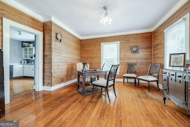 120 Newton St, Pooler, GA 31322 - dining area with wood walls, a chandelier, light wood-style flooring, baseboards, and an office area