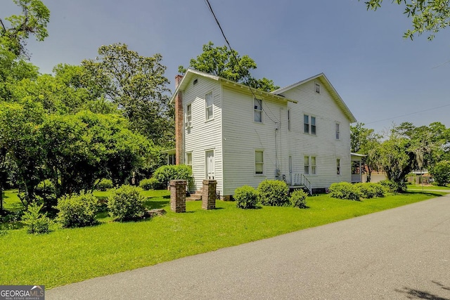 120 Newton St, Pooler, GA 31322 - view of property exterior with a chimney and a lawn