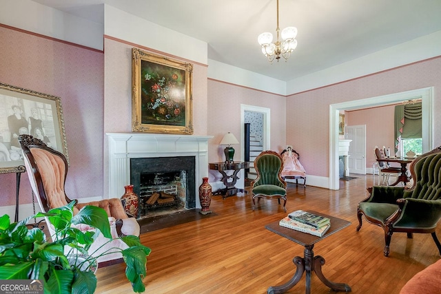 120 Newton St, Pooler, GA 31322 - living room featuring a fireplace with flush hearth, wood finished floors, a chandelier, and wallpapered walls