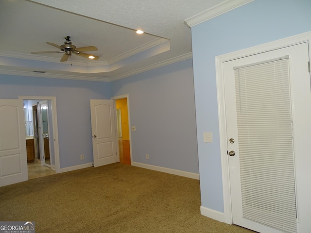 228 Laurel Landing Blvd, Kingsland, GA 31548 - unfurnished bedroom with ornamental molding, a tray ceiling, light carpet, baseboards, and ensuite bath