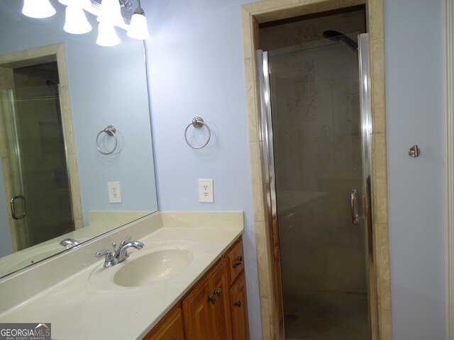 228 Laurel Landing Blvd, Kingsland, GA 31548 - bathroom featuring vanity, a stall shower, and a chandelier