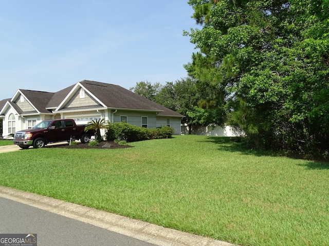 228 Laurel Landing Blvd, Kingsland, GA 31548 - view of home's exterior with a lawn and an attached garage