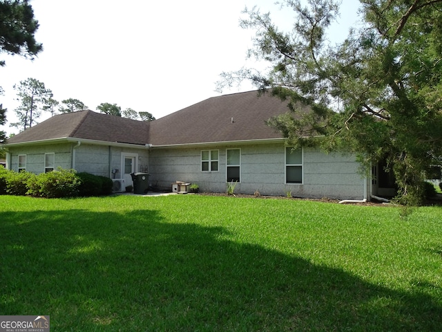 228 Laurel Landing Blvd, Kingsland, GA 31548 - back of property with a yard and roof with shingles