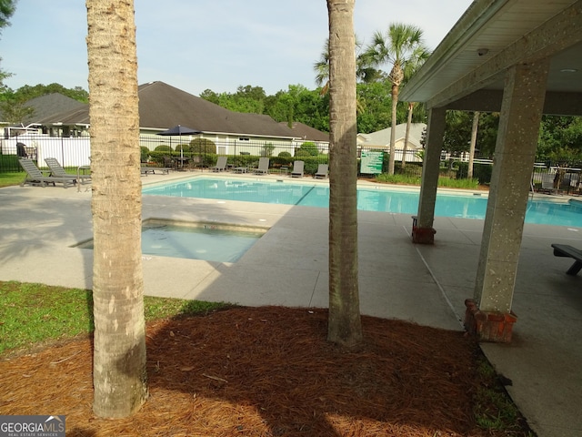 228 Laurel Landing Blvd, Kingsland, GA 31548 - community pool featuring a fenced backyard and a patio area