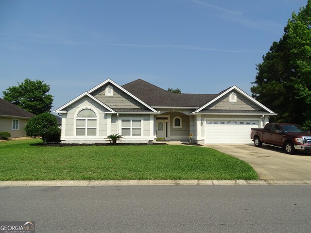 228 Laurel Landing Blvd, Kingsland, GA 31548 - ranch-style house with a front yard, an attached garage, driveway, and a shingled roof