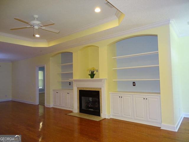 228 Laurel Landing Blvd, Kingsland, GA 31548 - unfurnished living room featuring ornamental molding, a raised ceiling, ceiling fan, wood finished floors, and a fireplace with flush hearth