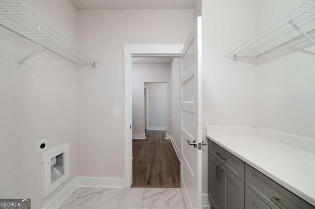 8370 Pleasant Grove Cir, Gainesville, GA 30506 - laundry room featuring electric dryer hookup, light marble finish floors, and cabinet space