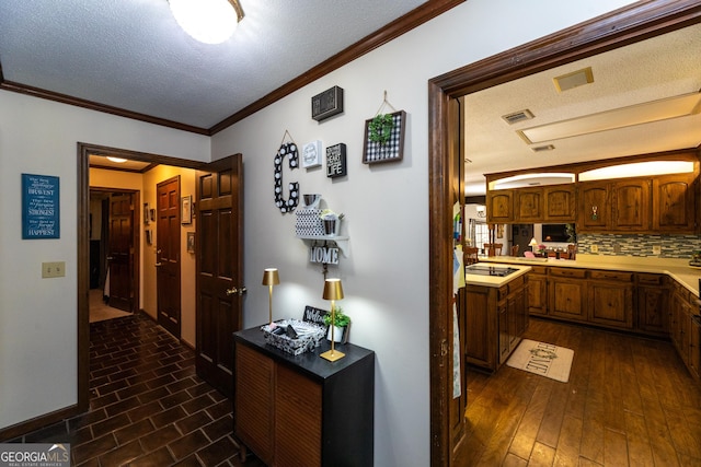 1701 City Blvd, Waycross, GA 31501 - corridor featuring a textured ceiling, crown molding, and dark wood-style floors