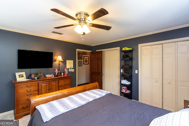 1701 City Blvd, Waycross, GA 31501 - bedroom featuring two closets, crown molding, a ceiling fan, and carpet flooring