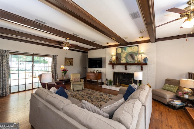 1701 City Blvd, Waycross, GA 31501 - living area featuring ceiling fan, wood finished floors, beam ceiling, and a fireplace
